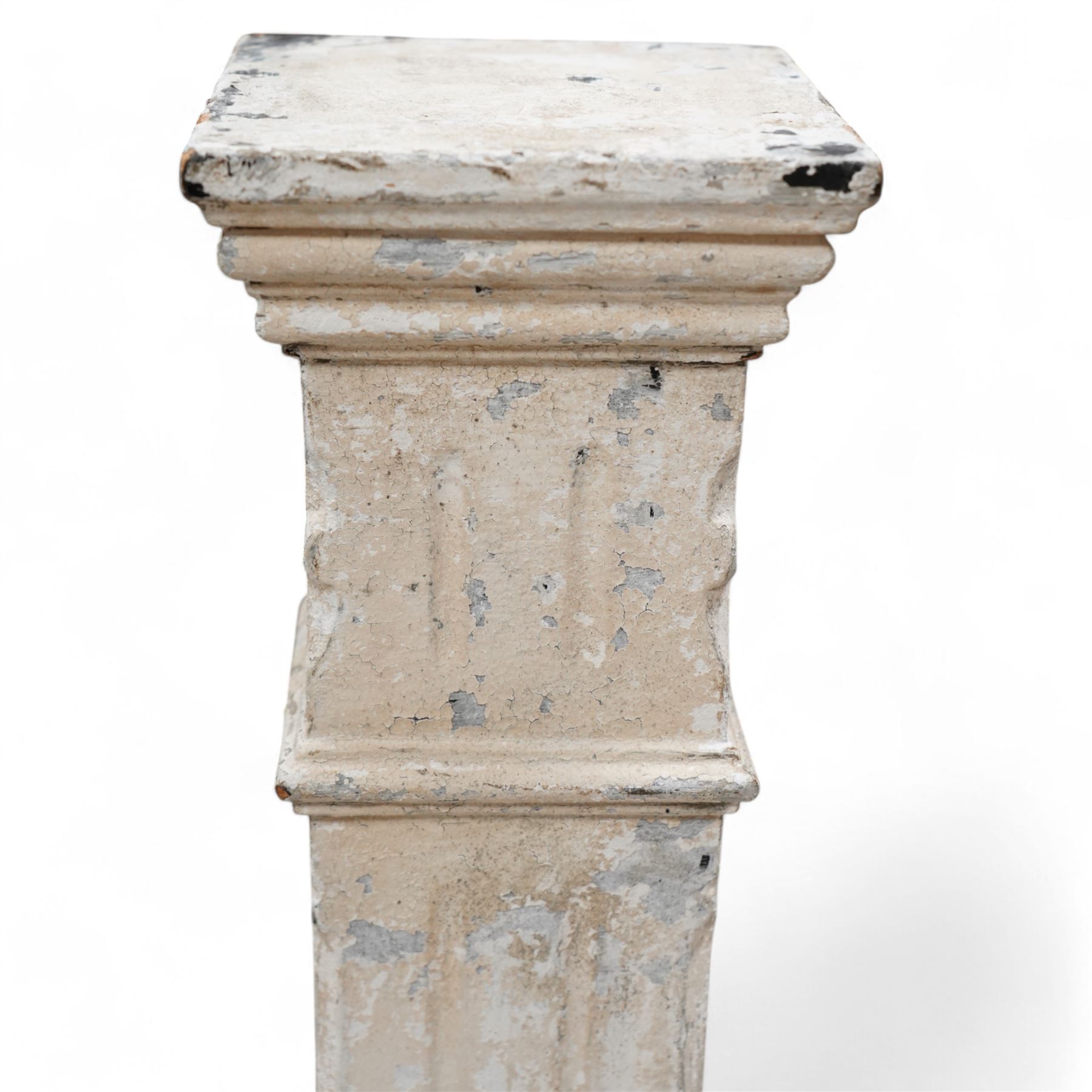 20th century painted wood pedestal, stepped square form with fluted decoration, terminating to moulded base, distressed white paint finish 