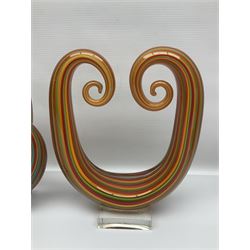 Three art glass sculpture, coiled form with multicolour stranded, upon clear glass plinth, unsigned, largest H27cm