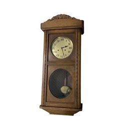 Two train oak cased wall clock, striking the hours on a coiled gong. With pendulum and key.