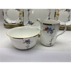 Art deco Shelley tea service for eight, decorated with floral sprigs, comprising teacup and saucers, dessert plates, two cake plates, milk jug and open sucrier, with to extra dessert plates