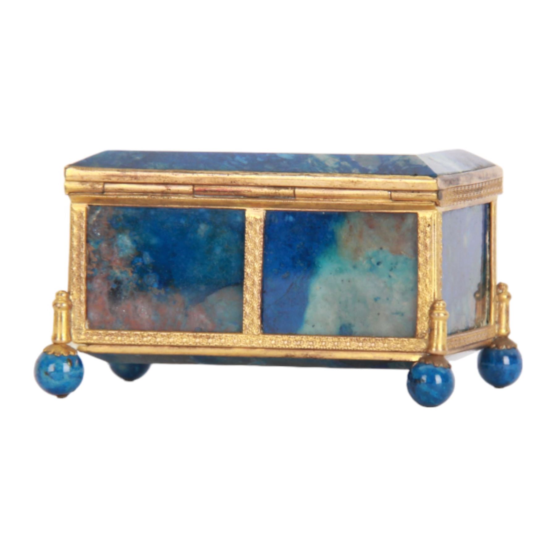 Small 19th century lapis lazuli casket, of rectangular form with gilt metal mounts, and bevel edged hinged cover, raised upon four lapis lazuli ball feet, H4cm L7.5cm D5cm