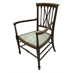 Edwardian inlaid mahogany armchair, curved top rail above spindle backrest with central X-shaped splat, the arms supported by turned uprights, over upholstered padded seat in pale blue damask fabric, on tapered supports with spade feet