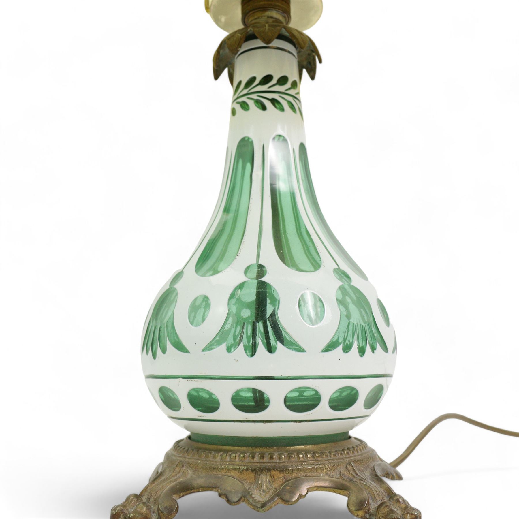 Early 20th century Bohemian green and white glass overlaid table lamp, of bulbous form with tapering neck, decorated with flower heads, with associated butterscotch mushroom form glass shade with wavy rim, on a cast brass base with four lion paw supports, H53cm