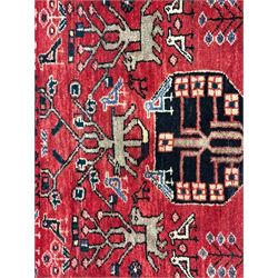 Persian crimson ground runner, the field decorated with stylised tree and animal motifs, indigo ground border decorated with alternating stylised flowerhead and bird motifs 