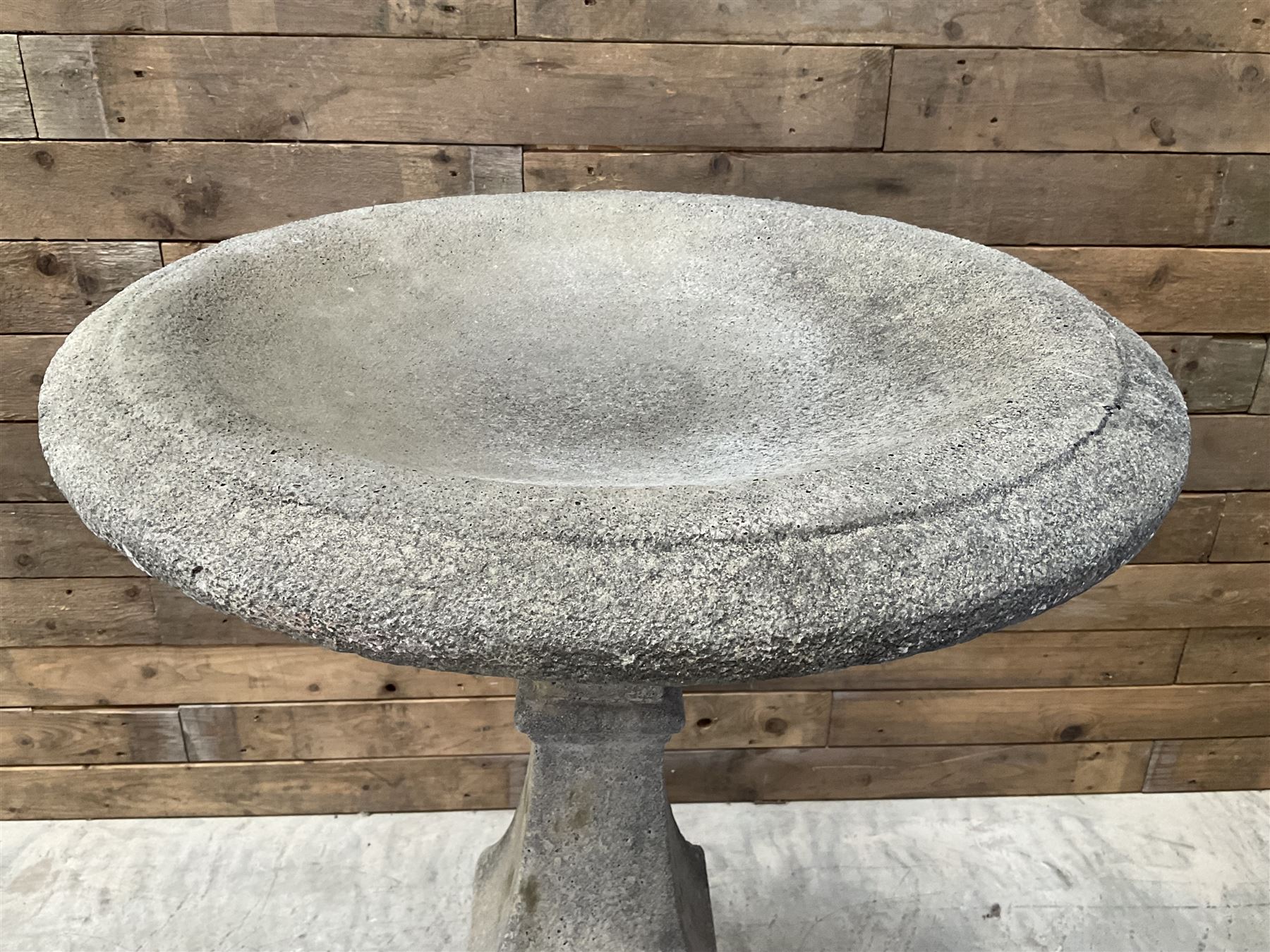 Cast stone garden bird bath, circular dished top, raised on square tapering column, on stepped base with separate mounting plinth