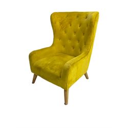 Mid-20th century design armchair, barrel back upholstered in buttoned mustard fabric, on tapering splayed front feet