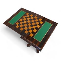 Regency rosewood games table, the rectangular swivel and fold-over chamfered top opening to reveal an inlaid checkerboard and baize lined playing surface, fitted with single concave frieze drawer over an upholstered sliding well fitted with compartments, supported with a U-shaped frame raised on an octagonal vasiform pedestal, terminating to a quadriform base with down-scrolled feet