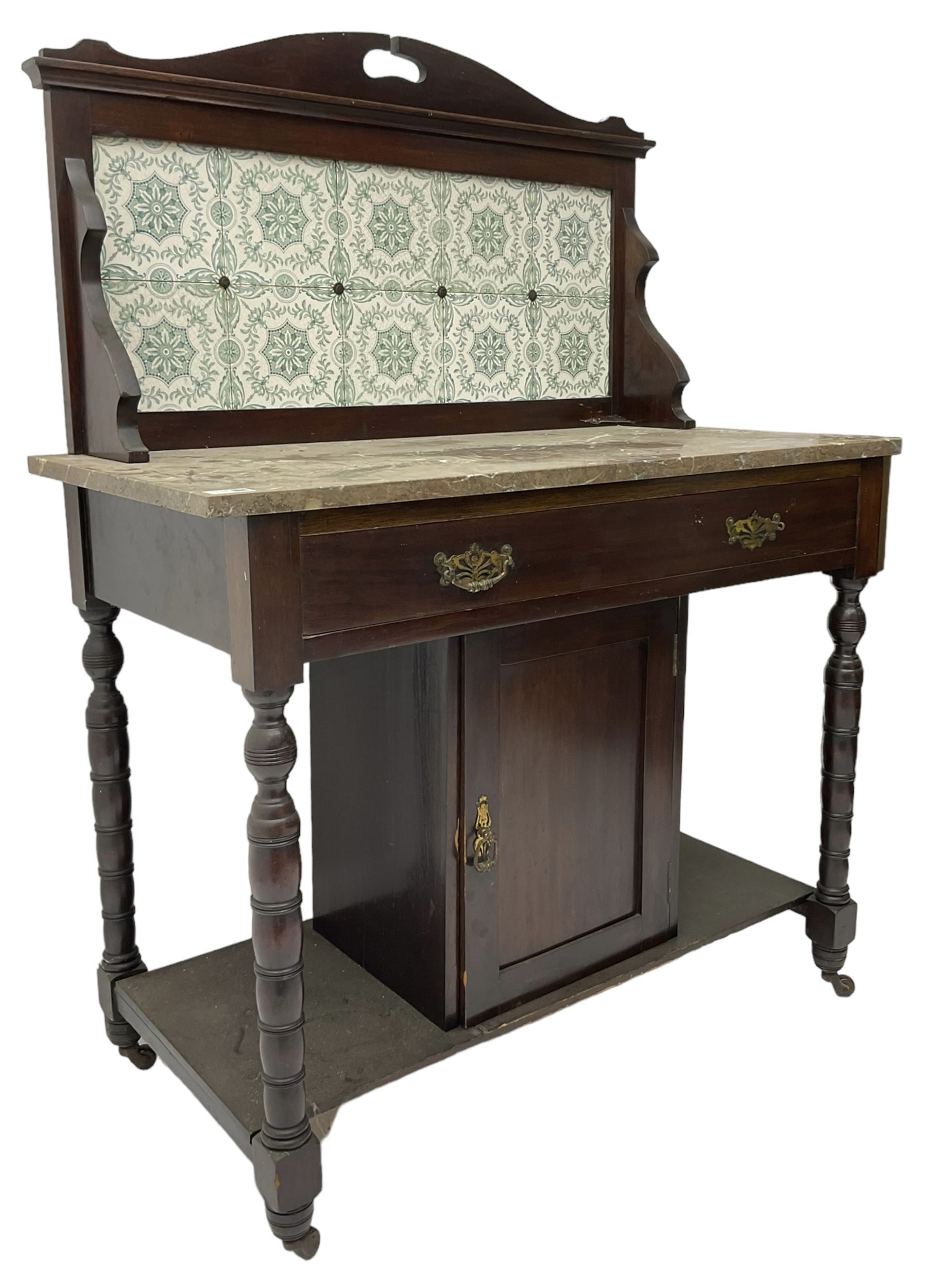 Edwardian walnut washstand, raised tiled back over marble table, fitted with single long drawer over panelled cupboard, on collar turned supports, brass and ceramic castors