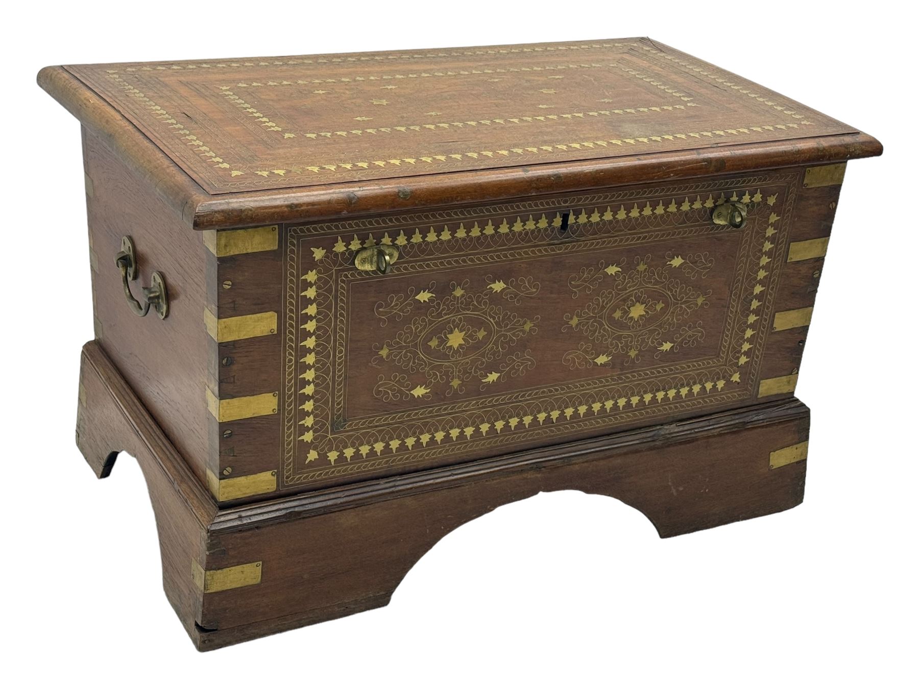 20th century mahogany chest, rectangular hinged top enclosing removable compartments with carved starburst motifs with linear and geometric patterns, brass inlay to the top and front, mounted corners and edges, on bracket base