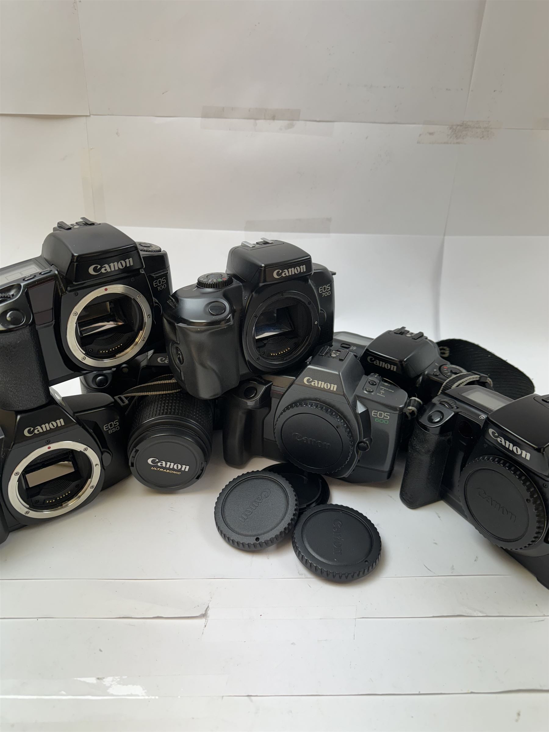 Seven Canon EOS camera bodies, to include EOS 5 serial no. 1172787, EOS 10 serial no. 1296930, EOS 30 serial no. (21)59004297 with a Canon EF 28-90mm 1:4-5.6 USM zoom lens, EOS 100 serial no. 75077188, EOS 600 serial no. 2641560, EOS 700 serial no. 1564248, EOS 850 serial no. 1164534