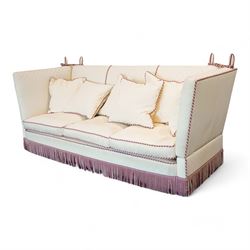 Grande Knole four-seat sofa, upholstered in geometric lozenge pattern cream fabric with burgundy and cream twist piping and fringe, on castors