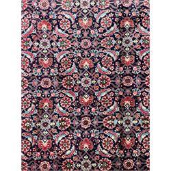 Persian Farahan indigo ground rug, the field decorated with large repeating floral herati motifs, crimson ground border decorated with palmettes and trailing leafy branch, within guard stripes 