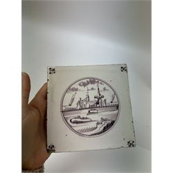 Four Dutch Delft manganese tiles, each depicting a river scene to the centre with a flower to each corner, each tile 12.5cm x 12.5cm