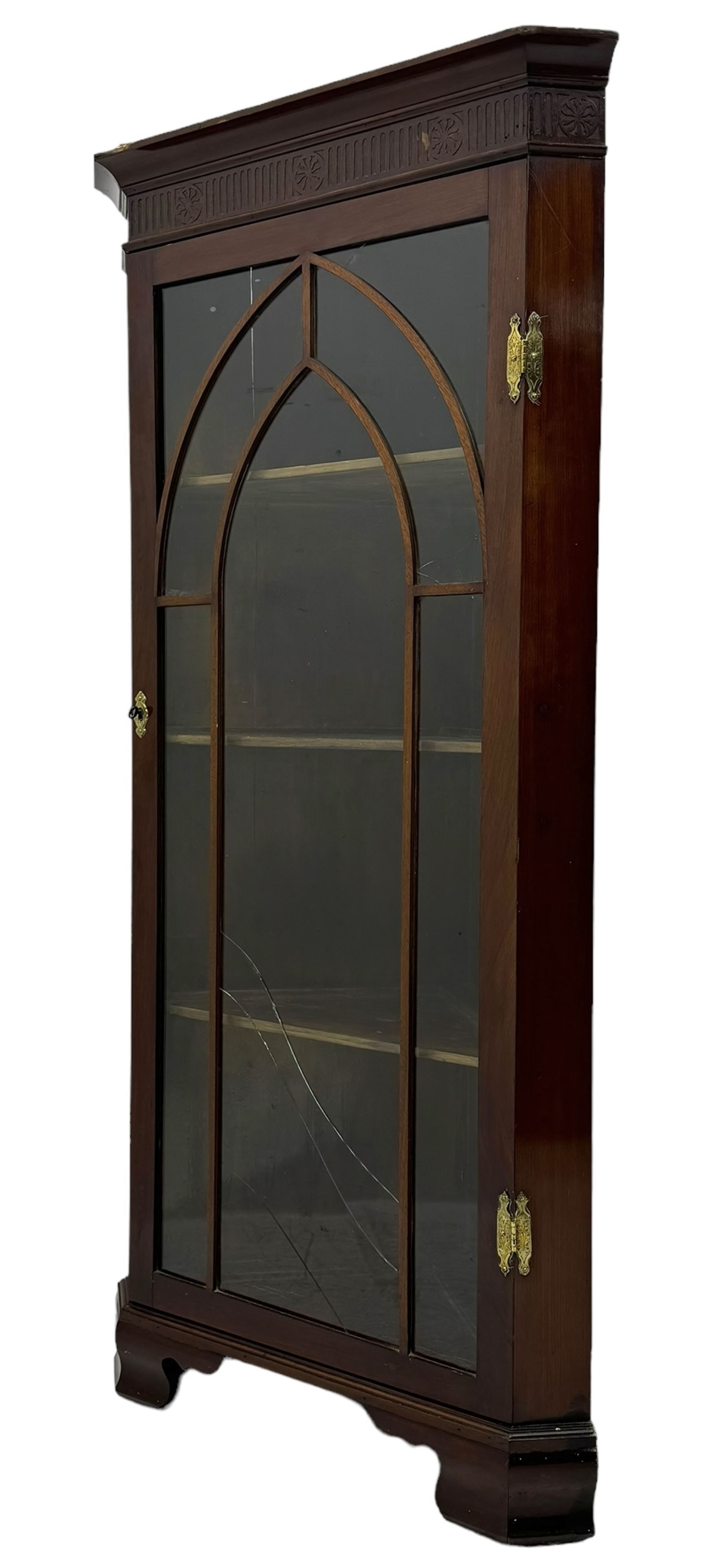 19th century mahogany floor-standing corner display cabinet, moulded cornice over blind fretwork frieze, enclosed by single astragal glazed door, the interior fitted with three shelves, on bracket feet