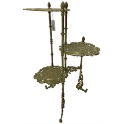 Cast gilt metal three-tier cake stand, each tier decorated with cast foliage scrolls and flower heads with a central bird motif, on turned and fluted supports with splayed C-scroll feet