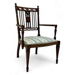 Edwardian inlaid rosewood elbow chair, pierced cresting rail over carved ribbon tie and oval inlaid panel, upholstered in stripe and floral pattern fabric, on square tapering supports with spade feet 