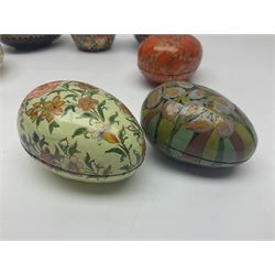 Seven lacquered boxes, of ovoid form, with floral decoration, largest H7cm, L10cm