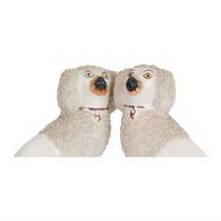 Pair of 19th century Staffordshire pottery dogs, circa 1860, modelled as Poodles with textured ears, upper bodies and tails, H16cm