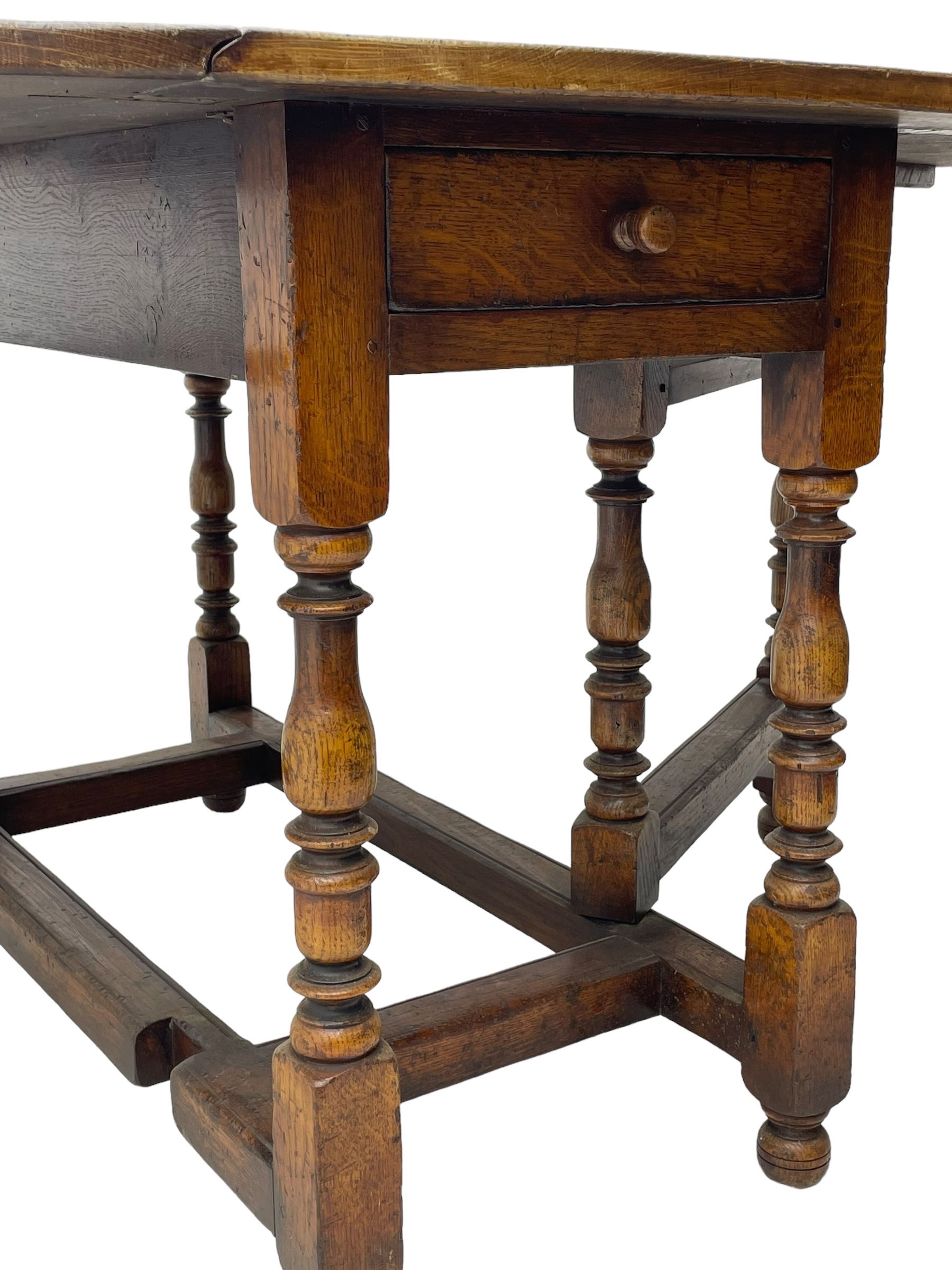 18th century oak dining table, oval drop-leaf top on gate-leg action base, turned supports united by turned stretchers, fitted with single end drawer