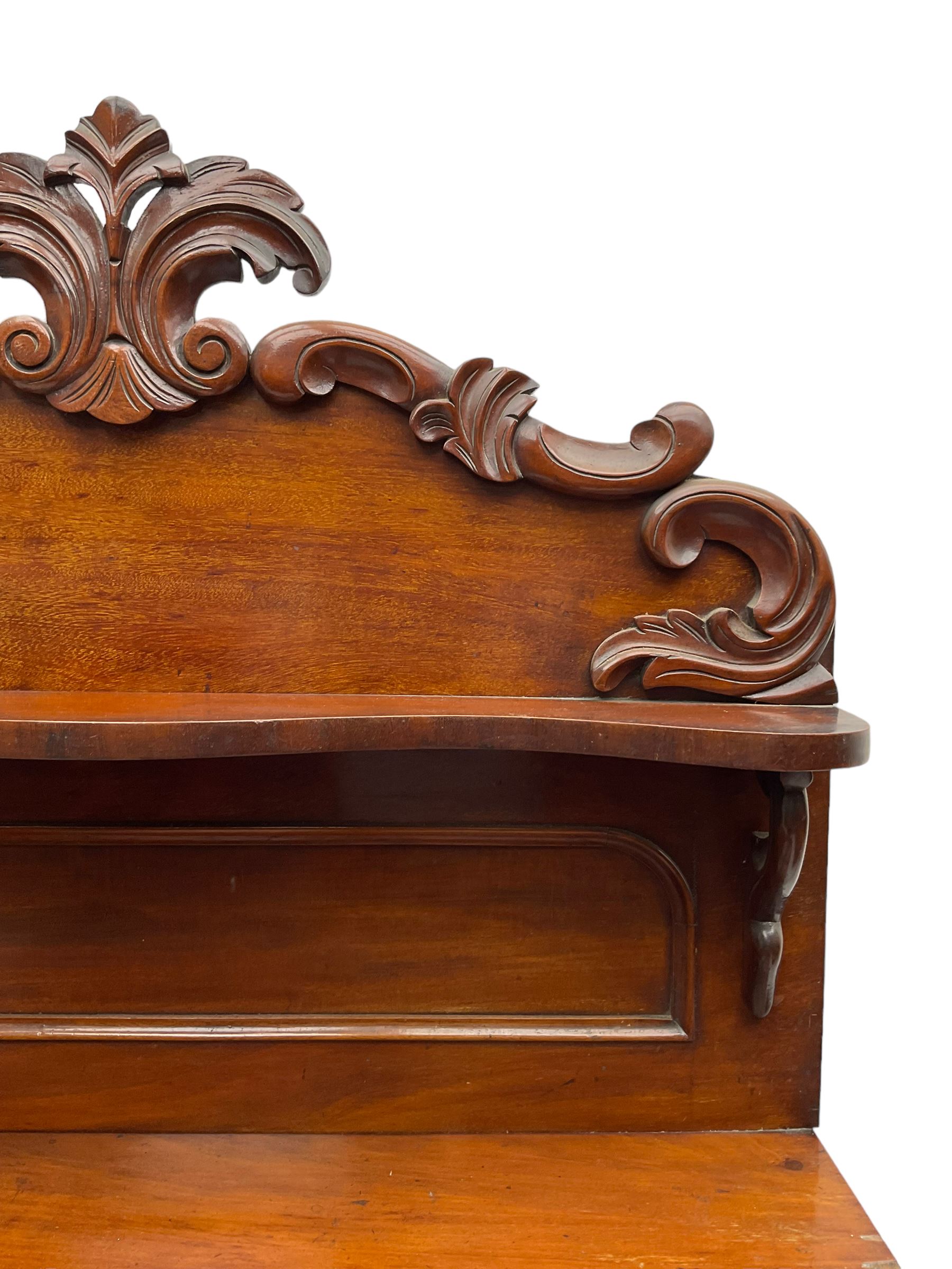 Victorian mahogany chiffonier, raised back with carved C-scroll foliage mounts and shelf, rectangular top with rounded corners over frieze drawer and double panelled cupboard, on skirted base