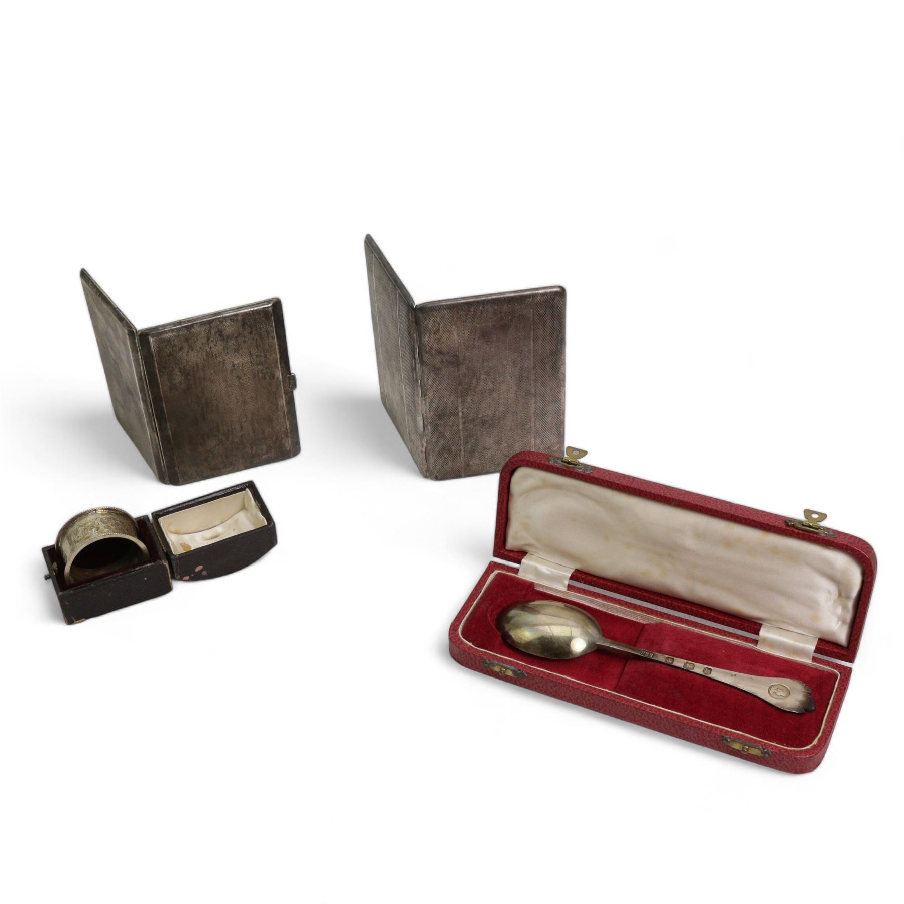 George VI engine turned silver cigarette case, hallmarked S Blanckensee & Son, Birmingham 1938, a silver plated cigarette case, an Elizabeth II commemorative coronation spoon, hallmarked Roberts & Belk, Sheffield 1953, cased and a boxed silver napkin ring