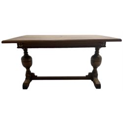 Early 20th century oak 'Ee-zi-Way one motion extending dining table', rectangular top over twin baluster end supports united by stretcher