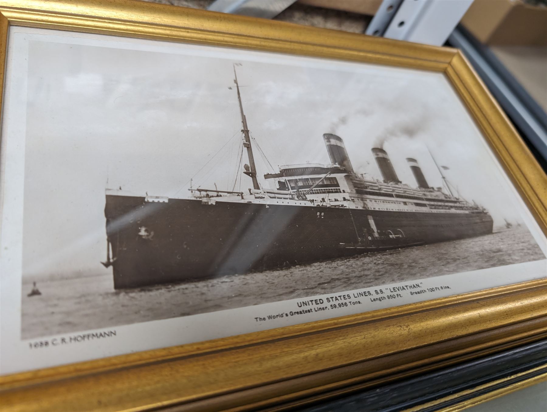 Two framed German shipping prints, together with a framed black and white postcard of United States Lines S.S. Leviathan