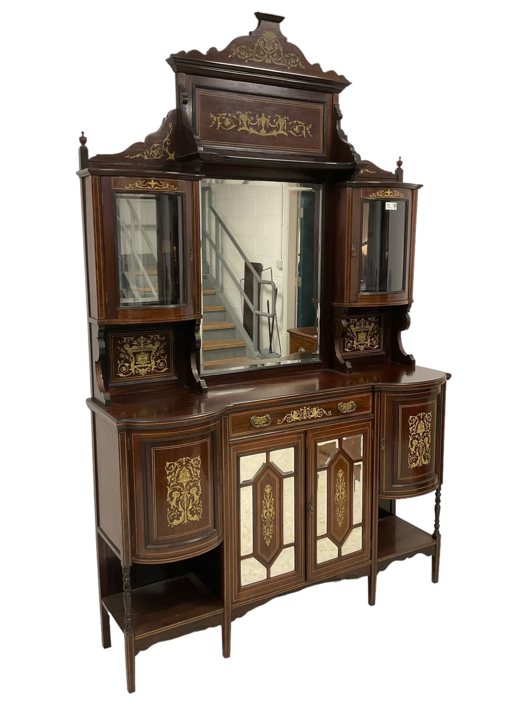 Late Victorian inlaid rosewood mirror back sideboard, shaped cresting rail decorated with scrolling foliate ivorine inlays, over rectangular bevelled mirror, flanked by bow-front glazed cupboards over inlaid 'green man' motifs, the base fitted with single drawer and cylindrical cupboards flanking a mirror panelled cupboard, on square tapering supports