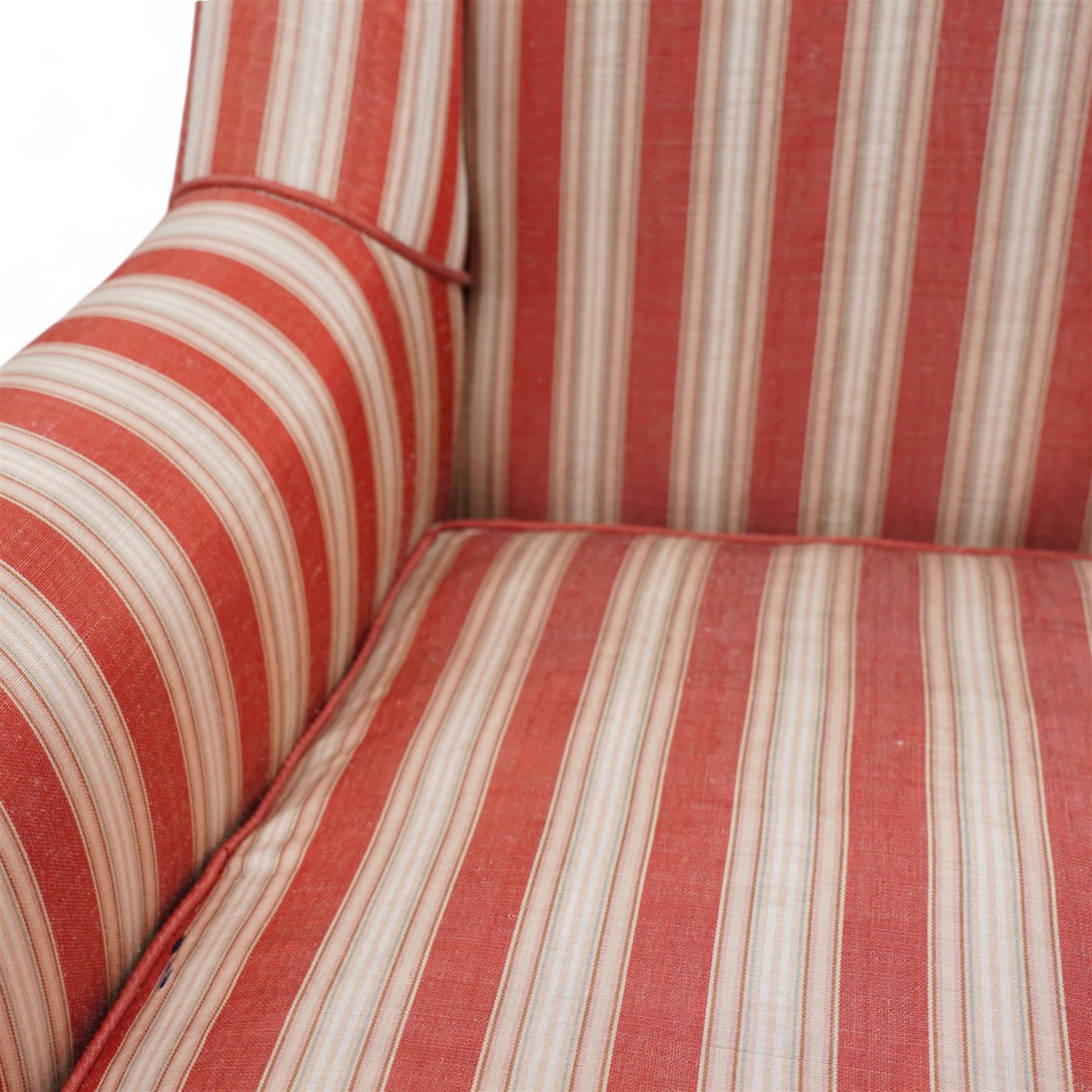 Edwardian hardwood-framed armchair, with rolled arms upholstered in red striped fabric, on square tapering front feet with brass and ceramic castors 