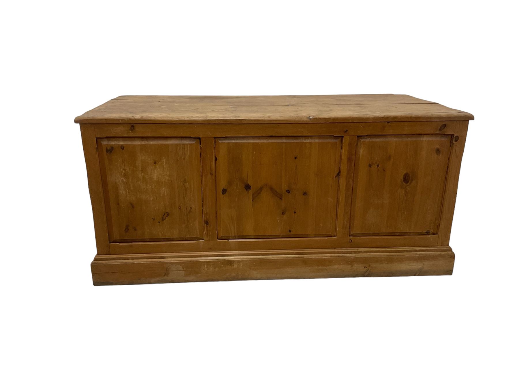 20th century waxed pine kneehole desk, rectangular top over nine drawers with cup handles, on moulded plinth base