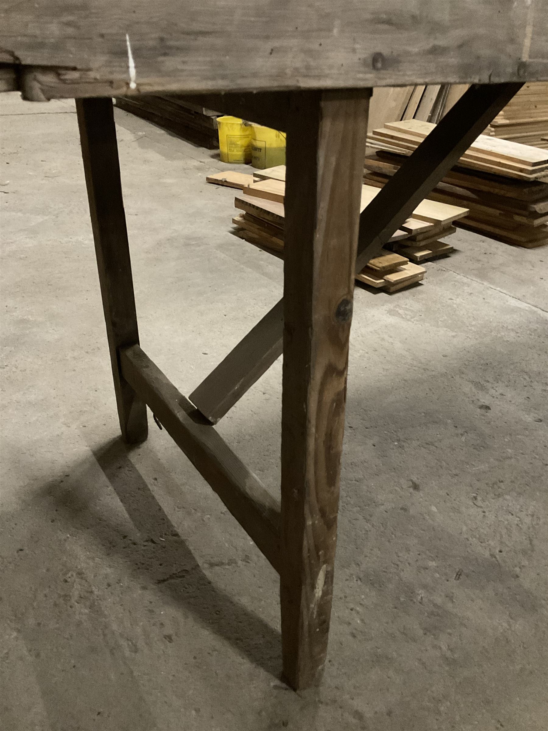 20the century pine folding table, rectangular top on square supports joined by stretchers (244cm x 68cm, H76cm); together with a similar folding bench (181cm x 25cm, H43cm) - THIS LOT IS TO BE COLLECTED BY APPOINTMENT FROM THE OLD BUFFER DEPOT, MELBOURNE PLACE, SOWERBY, THIRSK, YO7 1QY