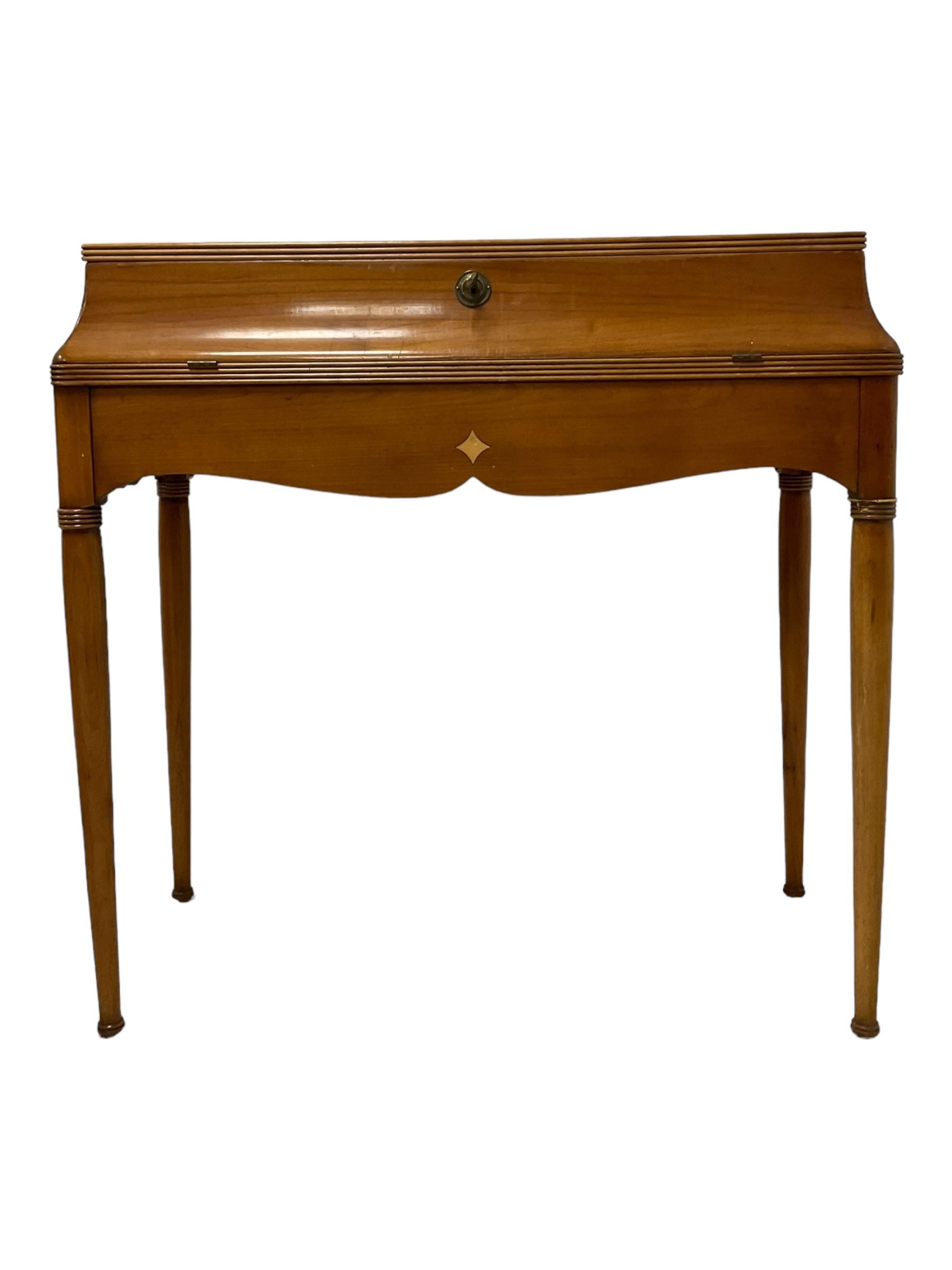 French design cherry wood dressing table, reed moulded hinged lid reveals mirror back, central compartment with lid and divisions, on turned supports