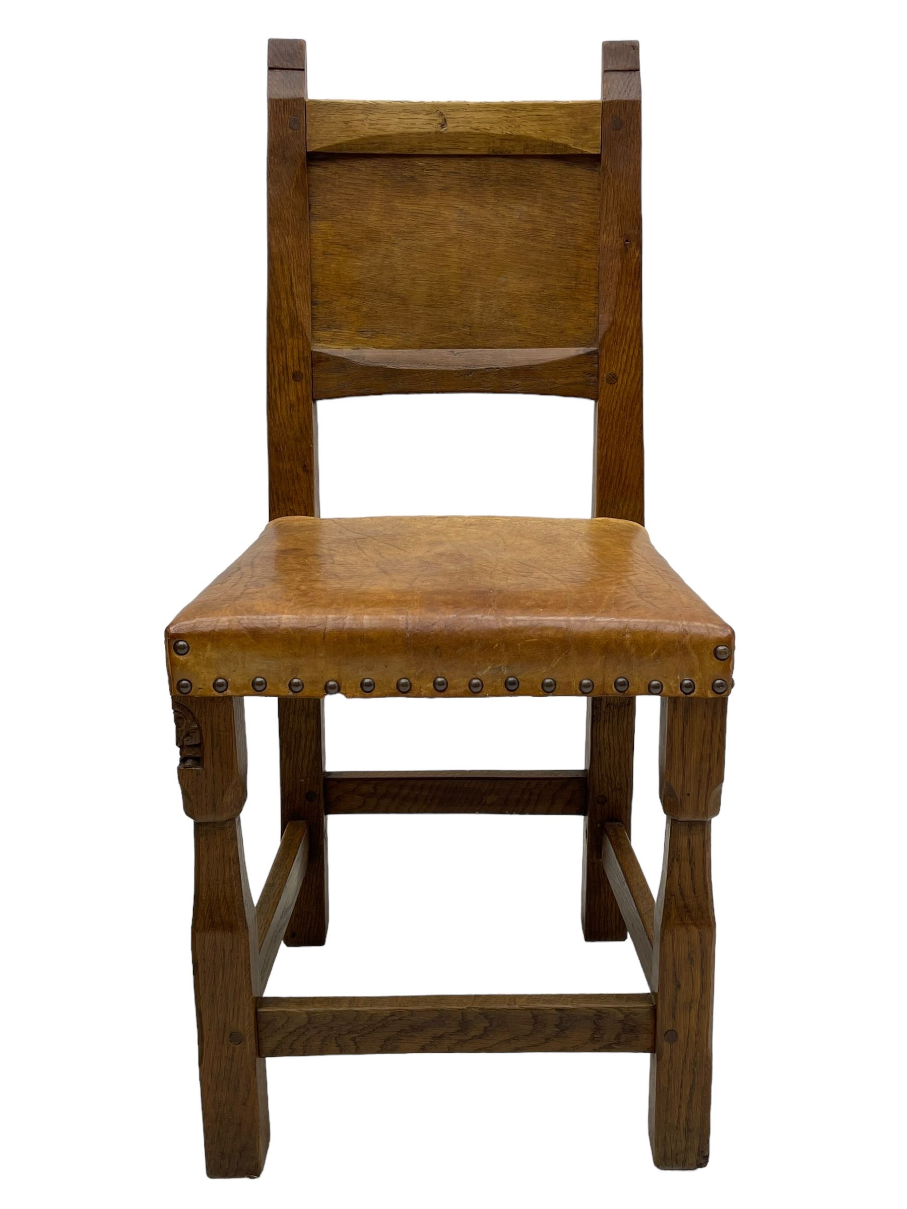 Gnomeman - set of eight (6+2) oak dining chairs, adzed panelled back over tan leather upholstered seat with applied stud band, on square supports united by plain stretchers, each chair carved with gnome signature, by Thomas Whittaker, Littlebeck, Whitby