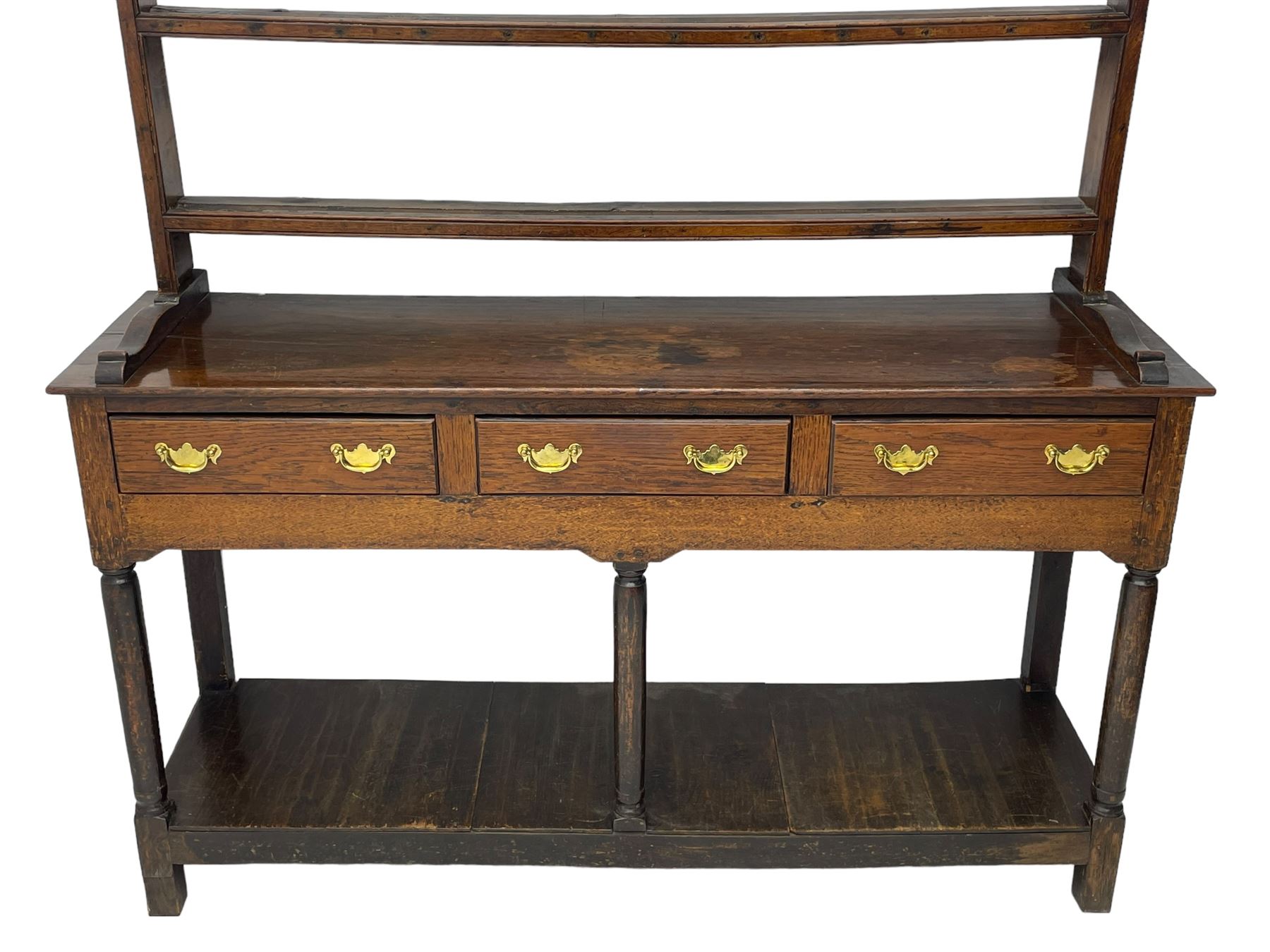 18th century oak dresser, raised three tier plate rack with moulded cresting rail, rectangular top over three drawers, the drawer fronts with moulded edges, turned supports united by pot board base 