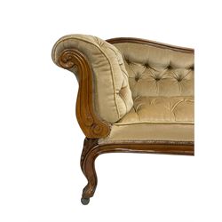 19th century walnut framed chaise longue, shaped back over scrolled arms decorated with moulded curling acanthus carvings, upholstered in deep buttoned champagne fabric, raised on cabriole supports with applied floral carved decoration, on castors