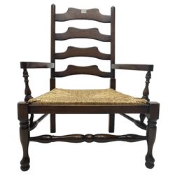 Oak low armchair, waived ladder back over rush seat, raised on turned  supports united by stretchers; together with matching stool