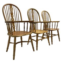 Near set of three 20th century pine Windsor chairs, high hoop stick back with pierced splat over shaped saddle seat, raised on ring turned supports