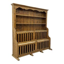 Waxed pine 'chicken coop' or 'hutch' dresser, projecting cornice over shaped frieze and three tier plate rack, the stepped waterfall lower section fitted with two slatted chicken coops, on sledge feet 