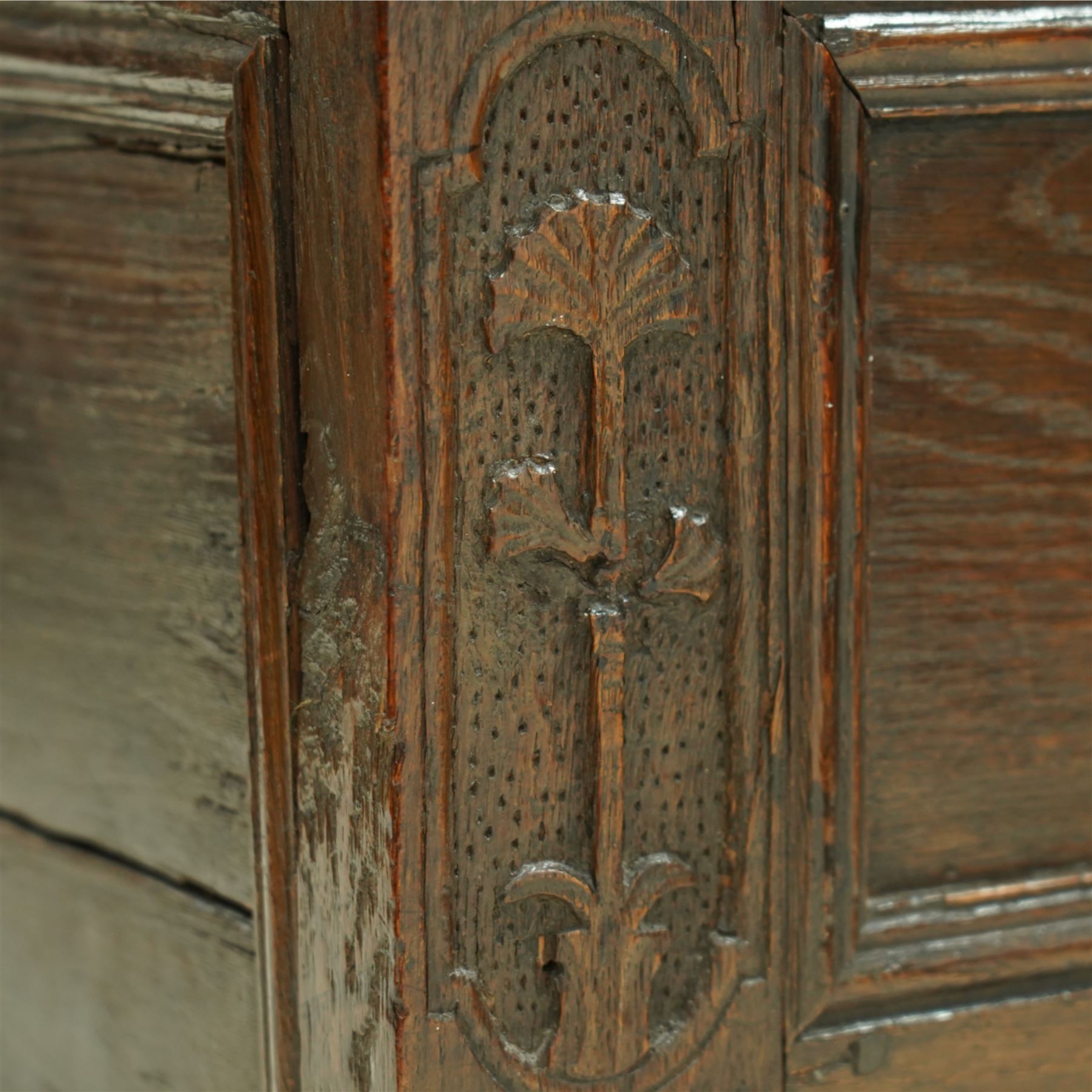 Small 18th century oak mule chest, rectangular hinged top top with moulded edge, enclosing candle box, over a double panelled front flanked by foliate carvings, single drawer fitted to base, on stile supports