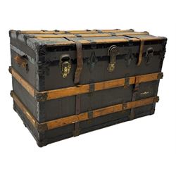 Early 20th century 'McBrine Baggage' steamer trunk, oak frame and black canvas covering, featuring metal hardware and leather straps, fitted with central lock, additional latches, and corner protectors, the interior is lined with floral-patterned paper and includes a removable top tray with makers label 