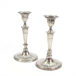 Pair of early 20th century silver candlesticks, of tapering oval form, with fluted decorat...