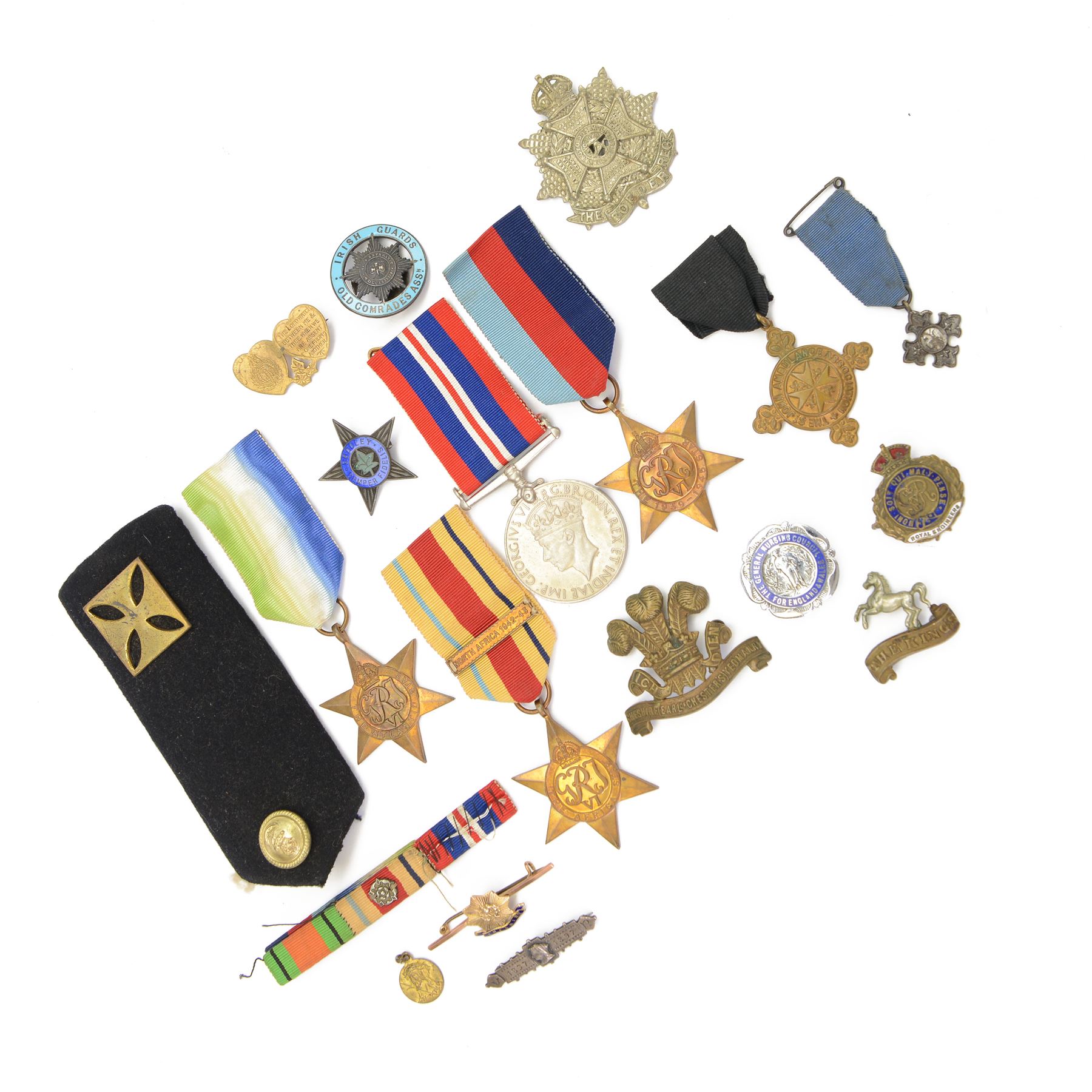 WWII group of four medals comprising 1939-45 star, Atlantic Star, African Star and War medal, together with various cap badges etc  