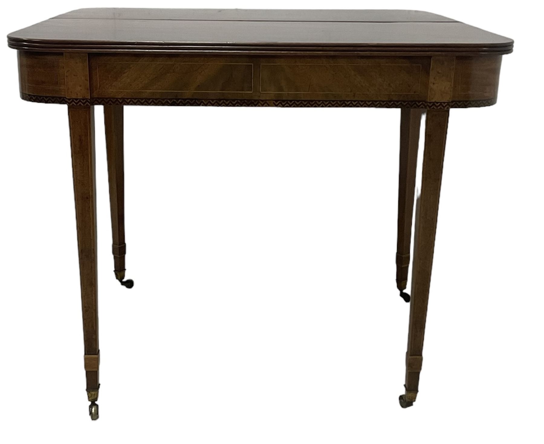 19th century mahogany tea table, fold-over top with reeded edge over inlaid frieze, on double gate-leg action square tapering supports, with brass castors