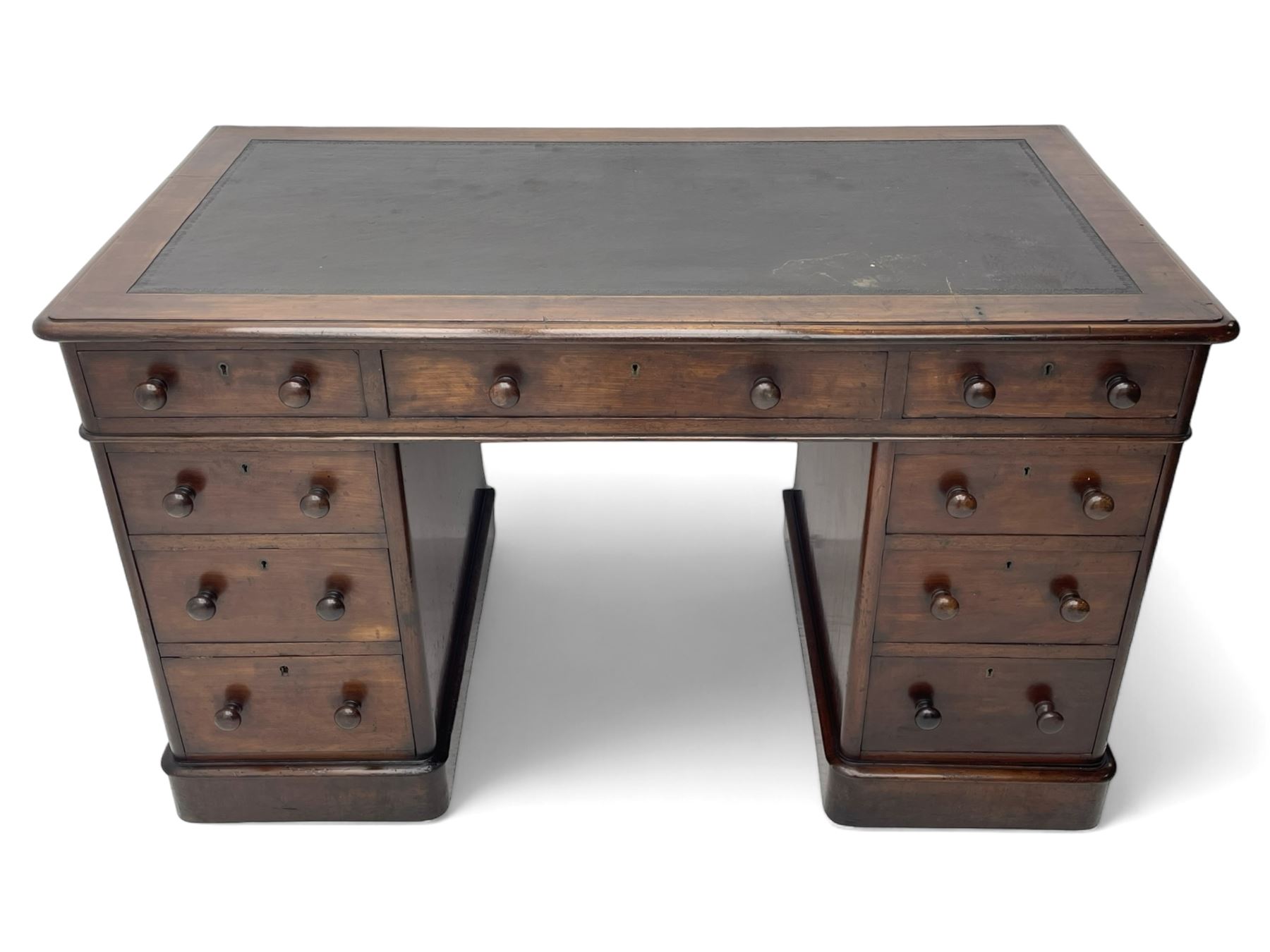 Victorian mahogany twin pedestal desk, moulded rectangular top with inset leather writing surface, nine drawers each fitted with two turned handles, on moulded plinth base 