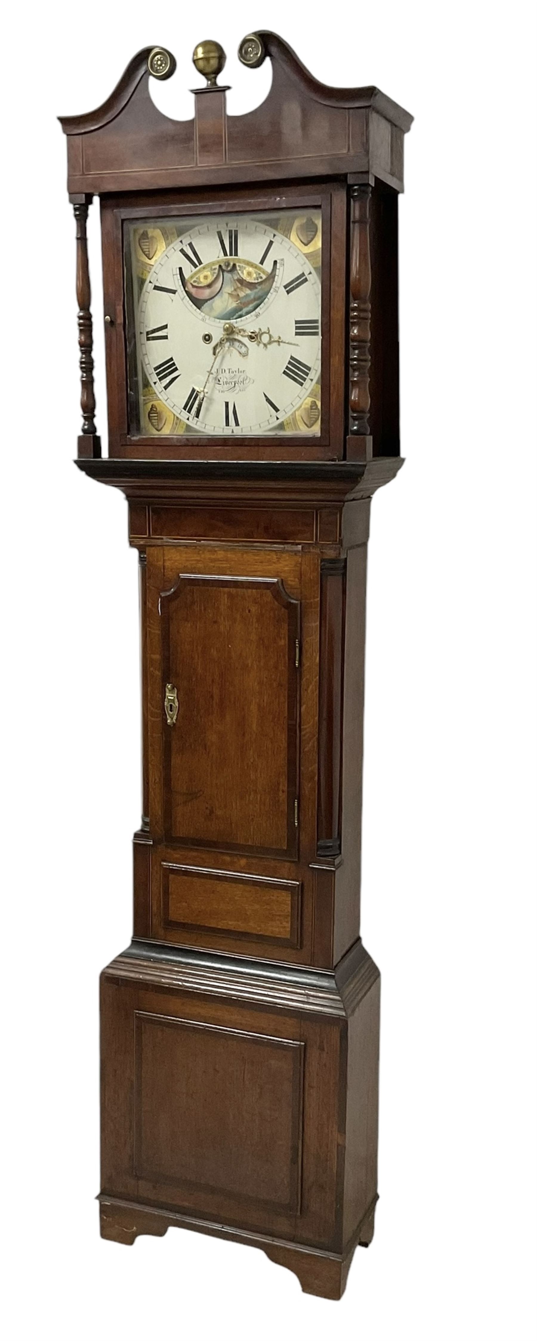 Taylor of Liverpool - mid 19th century 8-day Oak and Mahogany longcase clock with a swans necked pediment and brass ball finial, with a square hood door beneath flanked by turned pilasters, trunk with a short crossbanded door and raised panel on a square plinth raised on bracket feet, painted dial with matching geometric spandrels including depictions of conche shells, Roman numerals, makers name, axe moon disc and calendar aperture, dial pinned via a false plate to a rack striking movement, striking the hours on a bell. With weights and pendulum.