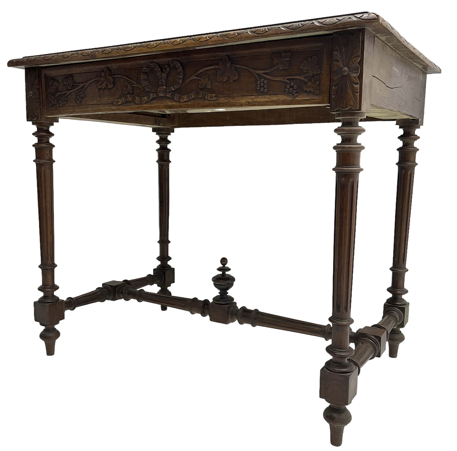 19th century walnut side table,  rectangular top with lunette carved moulded edge, the frieze drawer carved with ribbon and extending vine branch and grapes, on turned and fluted supports united by fluted stretcher with centre finial 