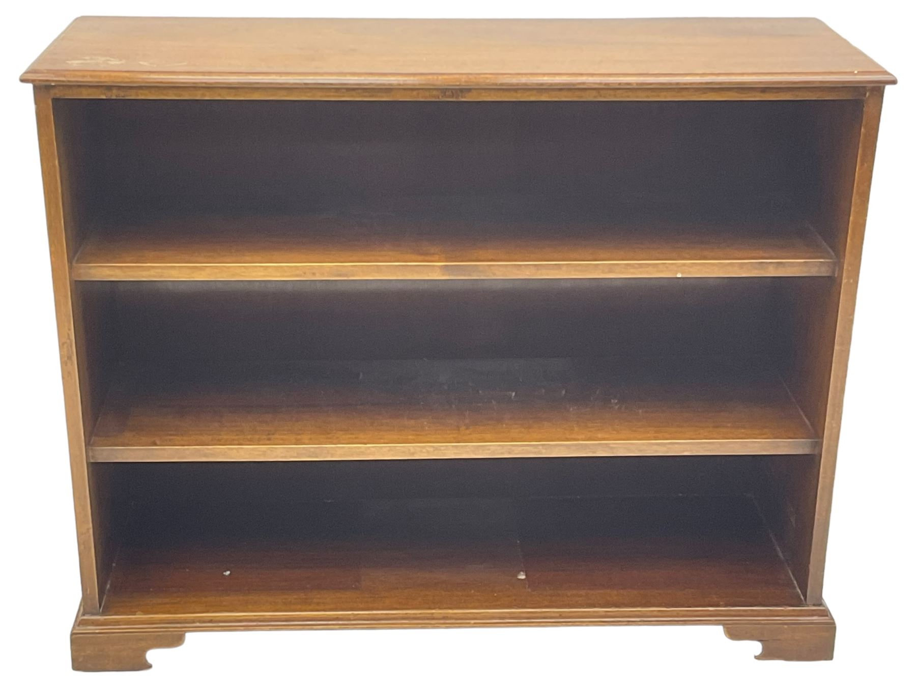 20th century mahogany open bookcase, fitted with two shelves, on bracket feet