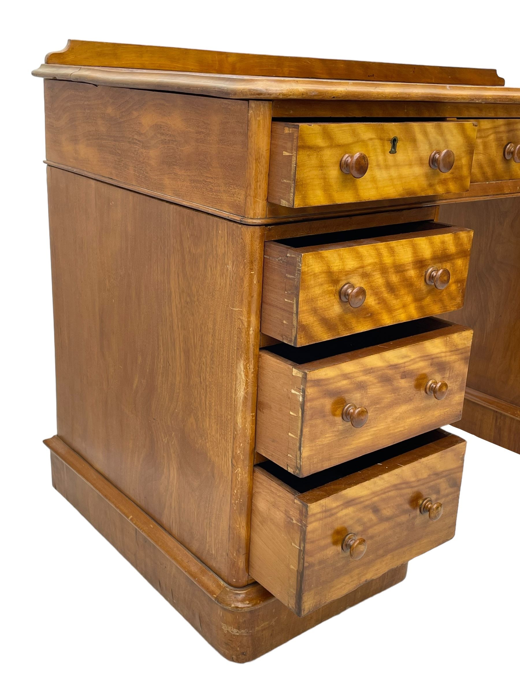 Victorian satin walnut twin pedestal desk, moulded rectangular top with rounded corners and raised back, inset leather writing surface with tooled borders, fitted with nine drawers with turned handles, on moulded plinth base 