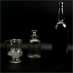 Glass coin jug, with ribbed body and inset with a George II silver 1d penny, H11cm; an 18th century Shrub decanter, circa 1785, H15.5cm; together with an 18th century English green wine bottle, H29.5cm (3)