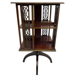 Edwardian mahogany revolving bookcase, square moulded top with satinwood band, two tiers with pierced vertical splats, on four curved supports 